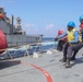 Sailors aboard the USS Rafael Peralta (DDG 115) conduct a replenishment-at-sea with the Lewis and Clark-class dry cargo USNS Wally Schirra (T-AKE-8) in the South China Sea