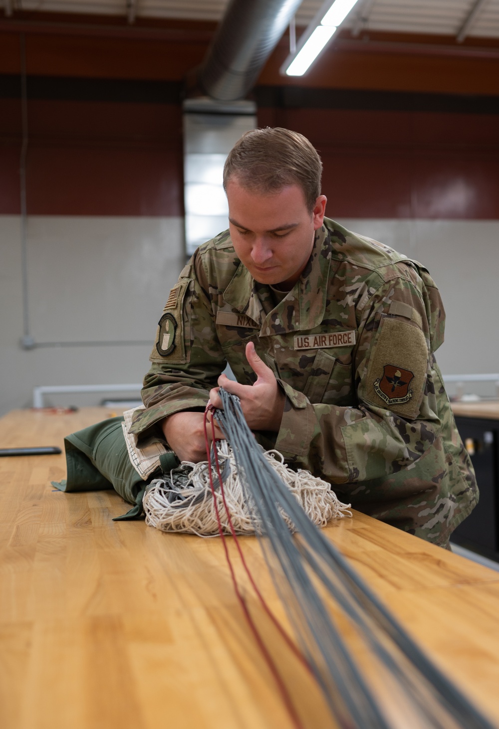 SERE Riggers Pack Parachutes for Training