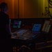 Musician 1st Class David Angell mixes on the sound board while performing at Howard Middle School Academy of Arts.