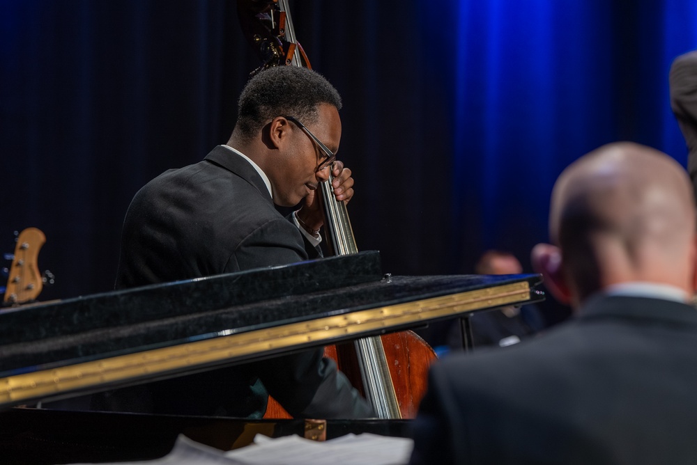 Musician 1st Class William Ledbetter plays the bass while performing at Howard Middle School Academy of Arts.
