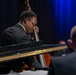 Musician 1st Class William Ledbetter plays the bass while performing at Howard Middle School Academy of Arts.