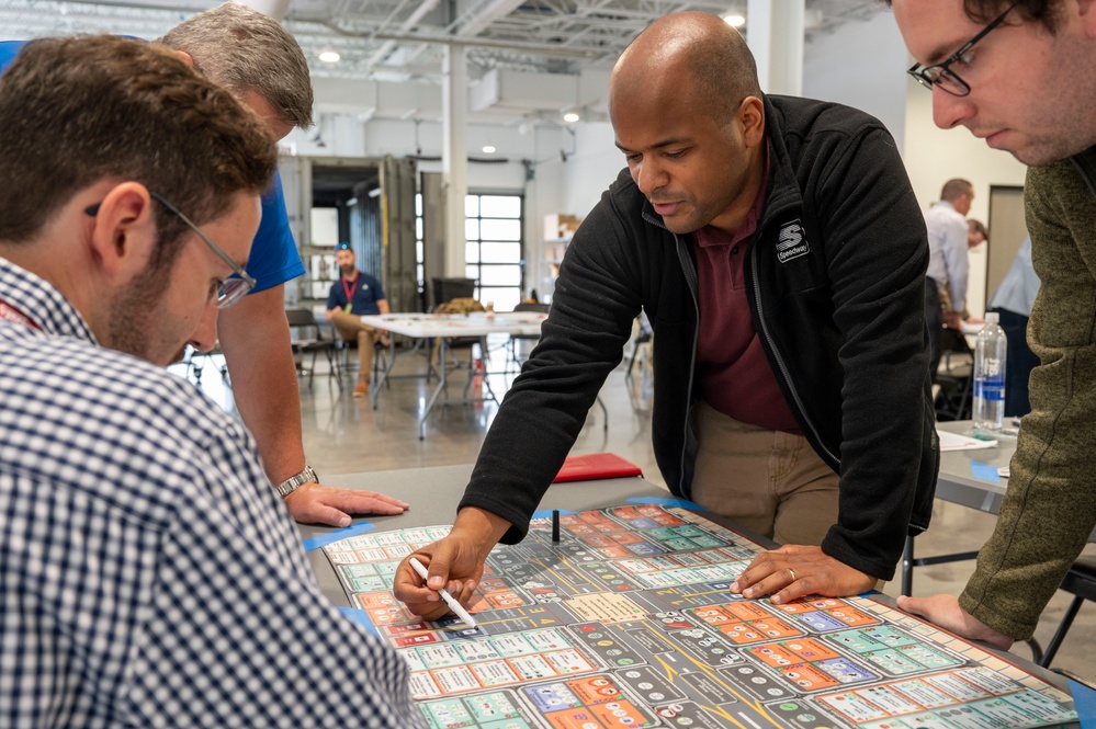 Individuals at the Rapid Sustainment Office learn how to play KingFish Ace