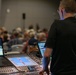 Musician 1st Class David Angell mans the sound board at the MetroHealth Stadium