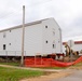 Contractors 'drive' World War II-era barracks buildings at Fort McCoy