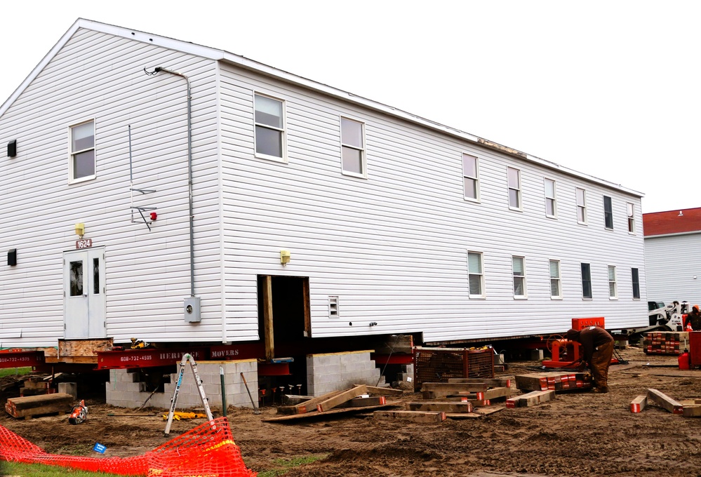 Contractors 'drive' World War II-era barracks buildings at Fort McCoy