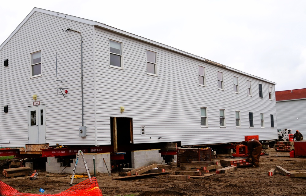 Contractors 'drive' World War II-era barracks buildings at Fort McCoy