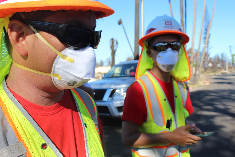 Quality Assurance Inspectors facilitate vehicle removal from the right of way in Lahaina, Hawai‘i