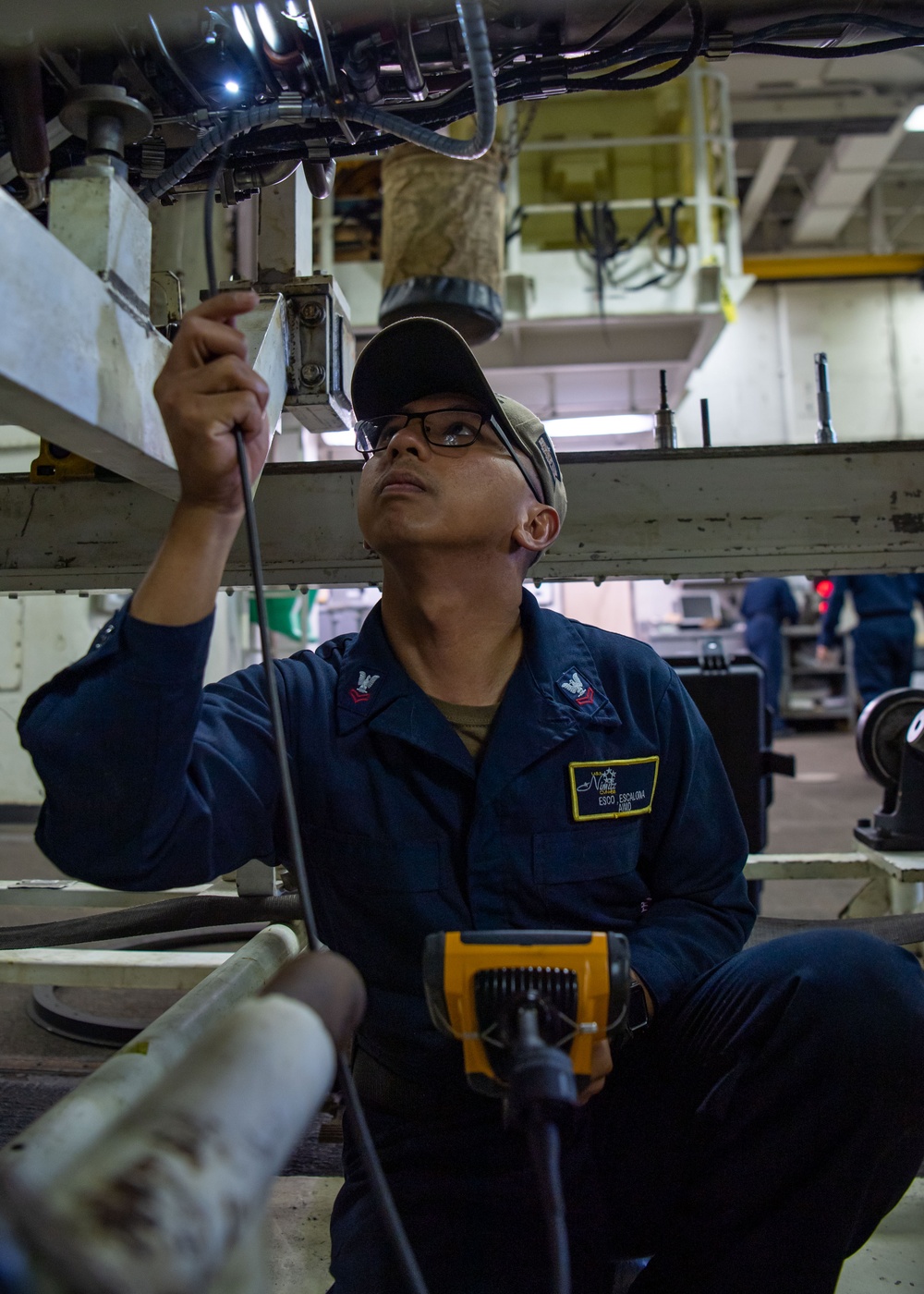 Sailor Conducts Engine Inspection
