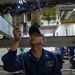 Sailor Conducts Engine Inspection