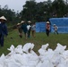 DPAA and Vietnamese locals build a cofferdam