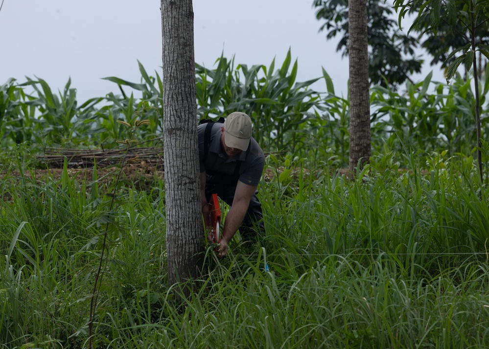 DPAA and Vietnamese locals build a cofferdam