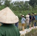 DPAA and Vietnamese locals build a cofferdam