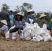 DPAA and Vietnamese locals build a cofferdam