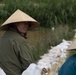 DPAA and Vietnamese locals build a cofferdam