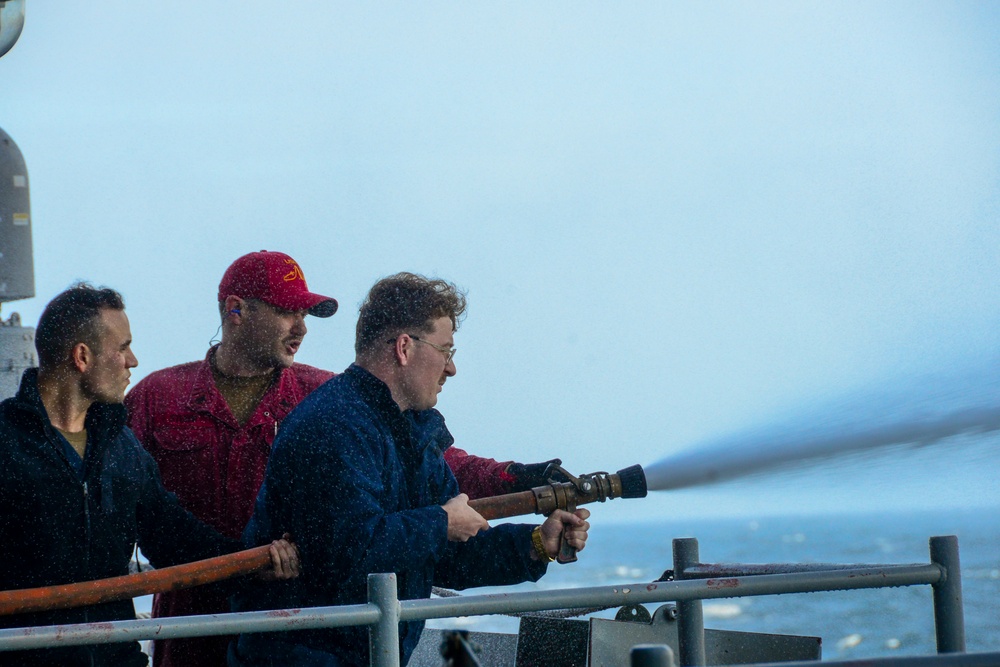 Sailors Handle Fire Hose