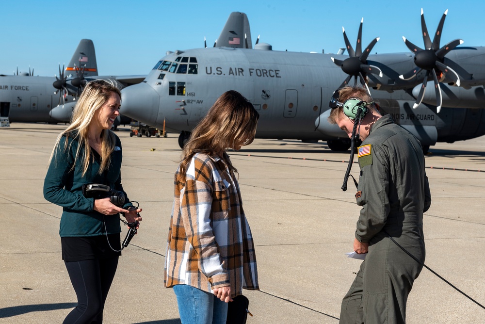 Spouses of members of the 182nd Operations Group fly on a C-130H3