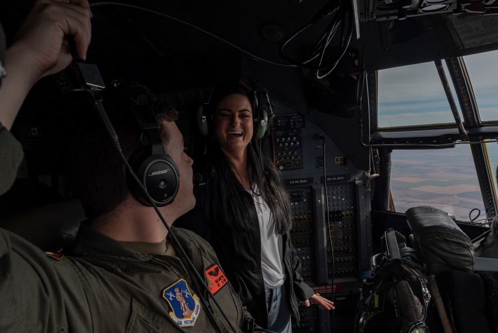 Spouses of members of the 182nd Operations Group fly on a C-130H3
