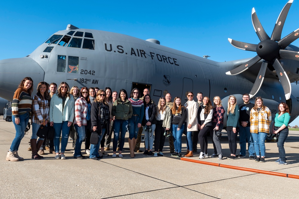 Spouses of members of the 182nd Operations Group fly on a C-130H3