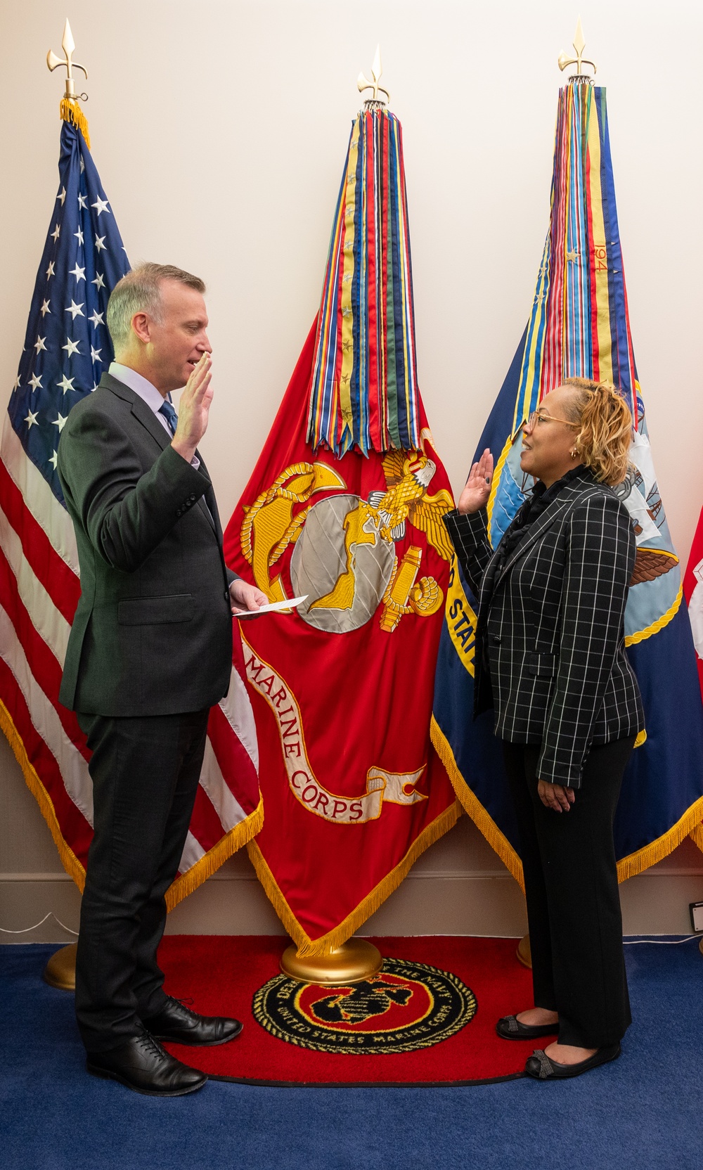 Under Secretary of the Navy administers the oath of office to Ms. Arveice Washington