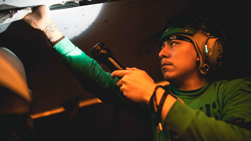 Sailor cleans aircraft aboard USS Carl Vinson (CVN 70)