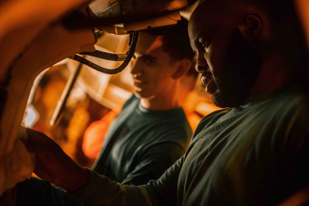 Sailor cleans aircraft aboard USS Carl Vinson (CVN 70)