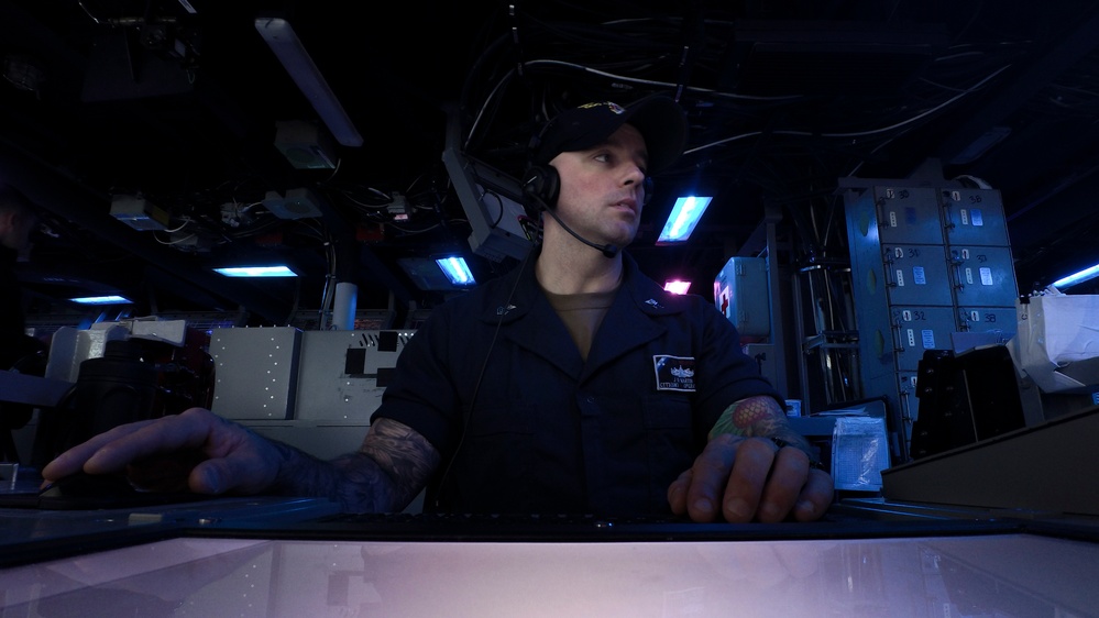 Sailors aboard USS Shoup stand watch in combat information center