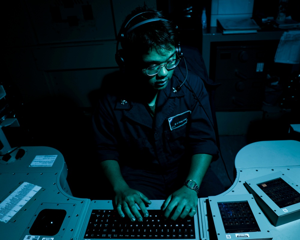 Sailors aboard USS Shoup stand watch in combat information center