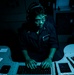 Sailors aboard USS Shoup stand watch in combat information center