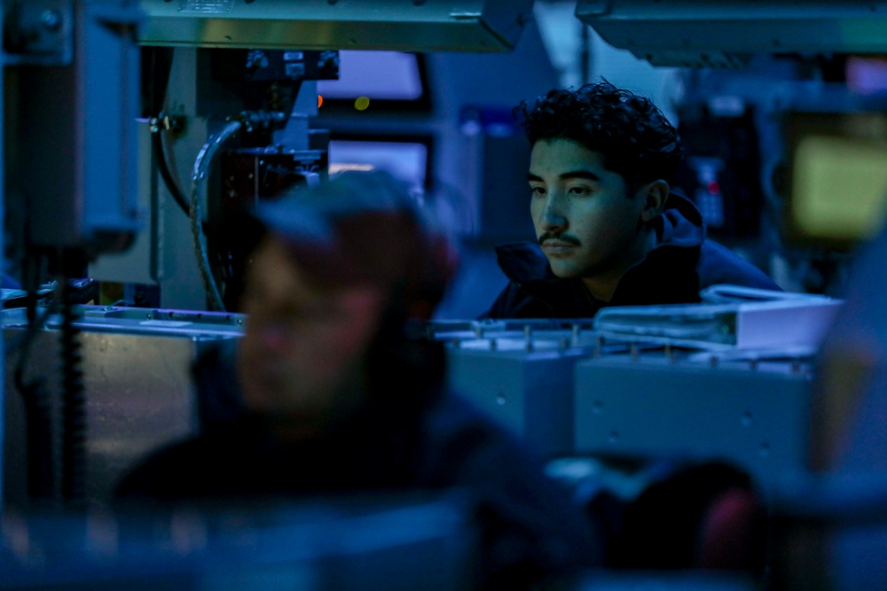 Sailors aboard USS Shoup stand watch in combat information center