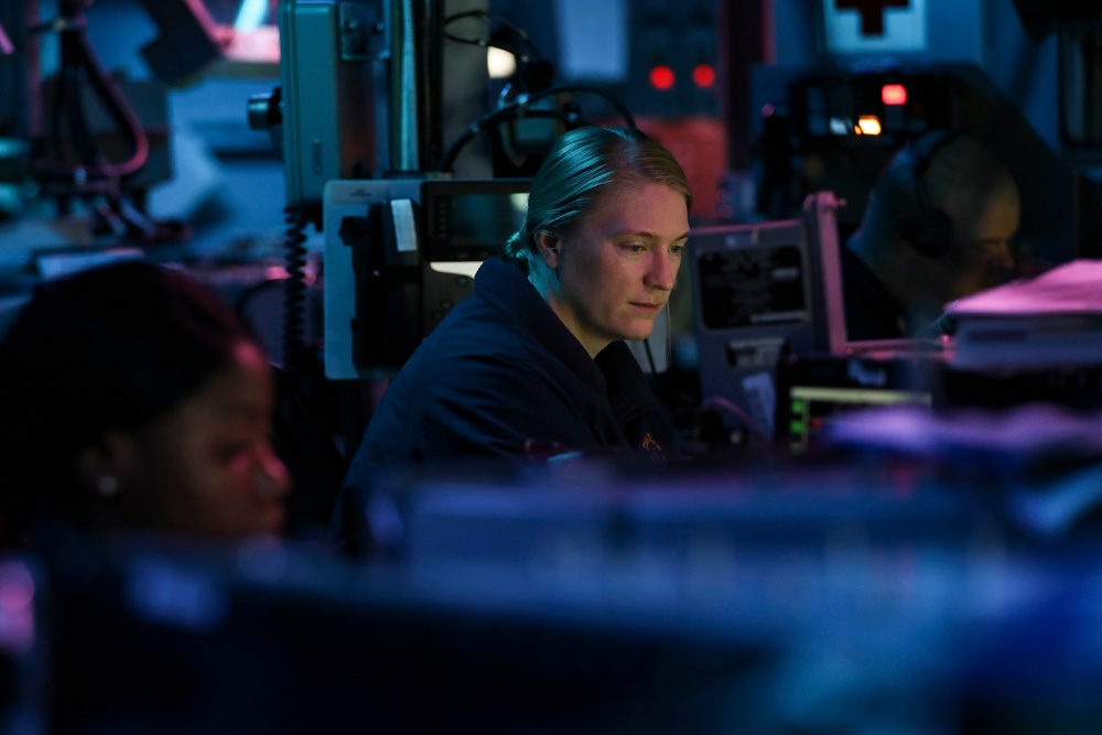 Sailors aboard USS Shoup stand watch in combat information center