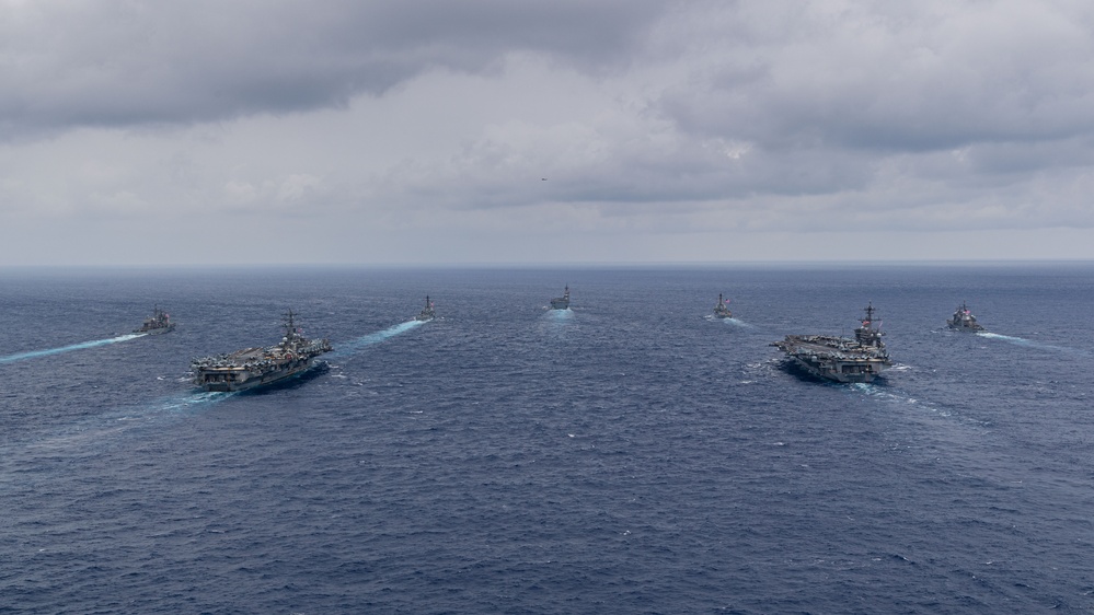 Ronald Reagan and Carl Vinson Carrier Strike Groups steam in formation with Japan Maritime Self-Defense Force (JMSDF) first-in-class helicopter destroyer JS Hyuga (DDH 181) during Multi-Large Deck Exercise