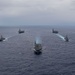 Ronald Reagan and Carl Vinson Carrier Strike Groups steam in formation with Japan Maritime Self-Defense Force (JMSDF) first-in-class helicopter destroyer JS Hyuga (DDH 181) during Multi-Large Deck Exercise