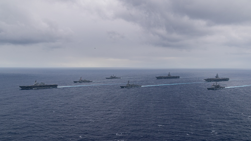 Ronald Reagan and Carl Vinson Carrier Strike Groups steam in formation with Japan Maritime Self-Defense Force (JMSDF) first-in-class helicopter destroyer JS Hyuga (DDH 181) during Multi-Large Deck Exercise