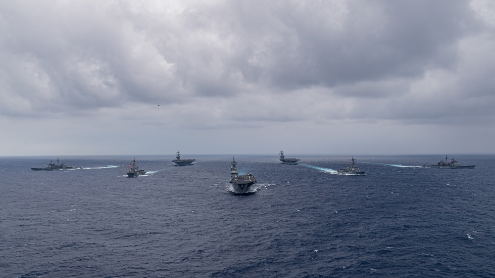 Ronald Reagan and Carl Vinson Carrier Strike Groups steam in formation with Japan Maritime Self-Defense Force (JMSDF) first-in-class helicopter destroyer JS Hyuga (DDH 181) during Multi-Large Deck Exercise