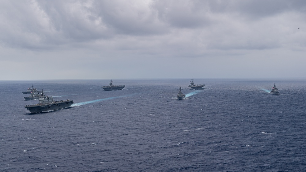 Ronald Reagan and Carl Vinson Carrier Strike Groups steam in formation with Japan Maritime Self-Defense Force (JMSDF) first-in-class helicopter destroyer JS Hyuga (DDH 181) during Multi-Large Deck Exercise