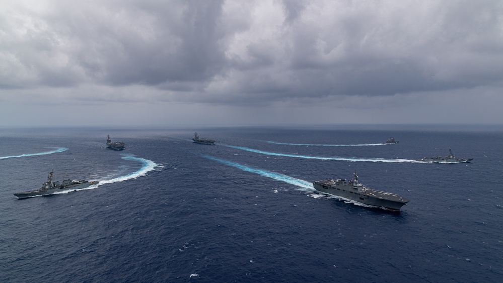 Ronald Reagan and Carl Vinson Carrier Strike Groups steam in formation with Japan Maritime Self-Defense Force (JMSDF) first-in-class helicopter destroyer JS Hyuga (DDH 181) during Multi-Large Deck Exercise