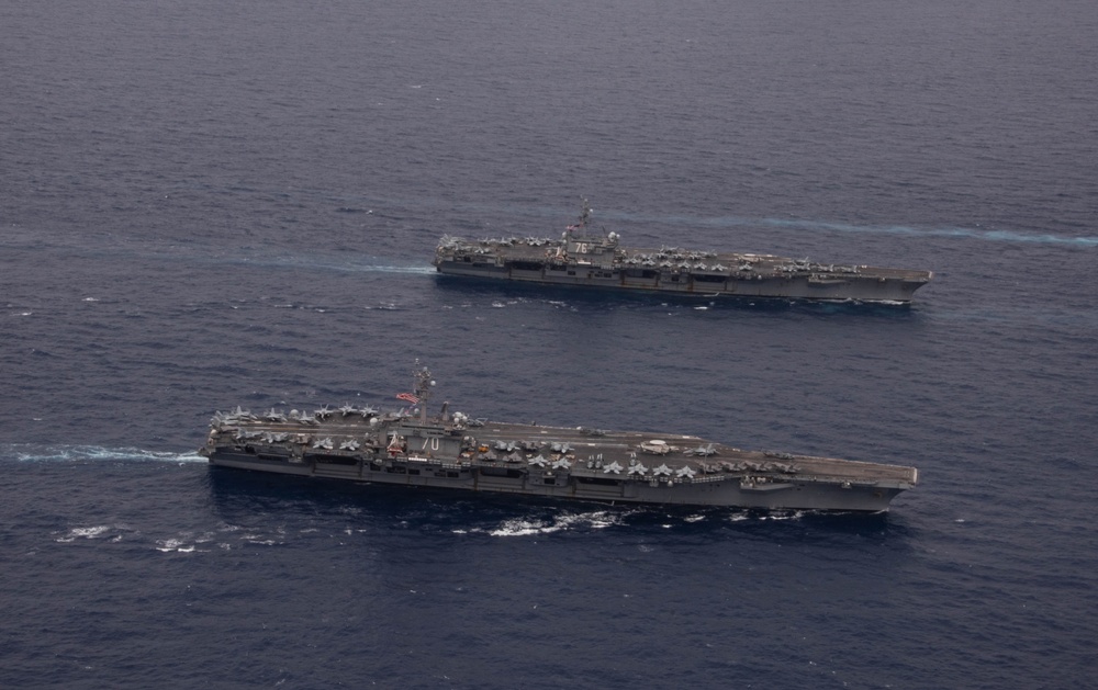 Ronald Reagan and Carl Vinson Carrier Strike Groups steam in formation with Japan Maritime Self-Defense Force (JMSDF) first-in-class helicopter destroyer JS Hyuga (DDH 181) during Multi-Large Deck Exercise