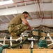 U.S. Army Parachute Rigger checks to ensure cargo was rigged correctly