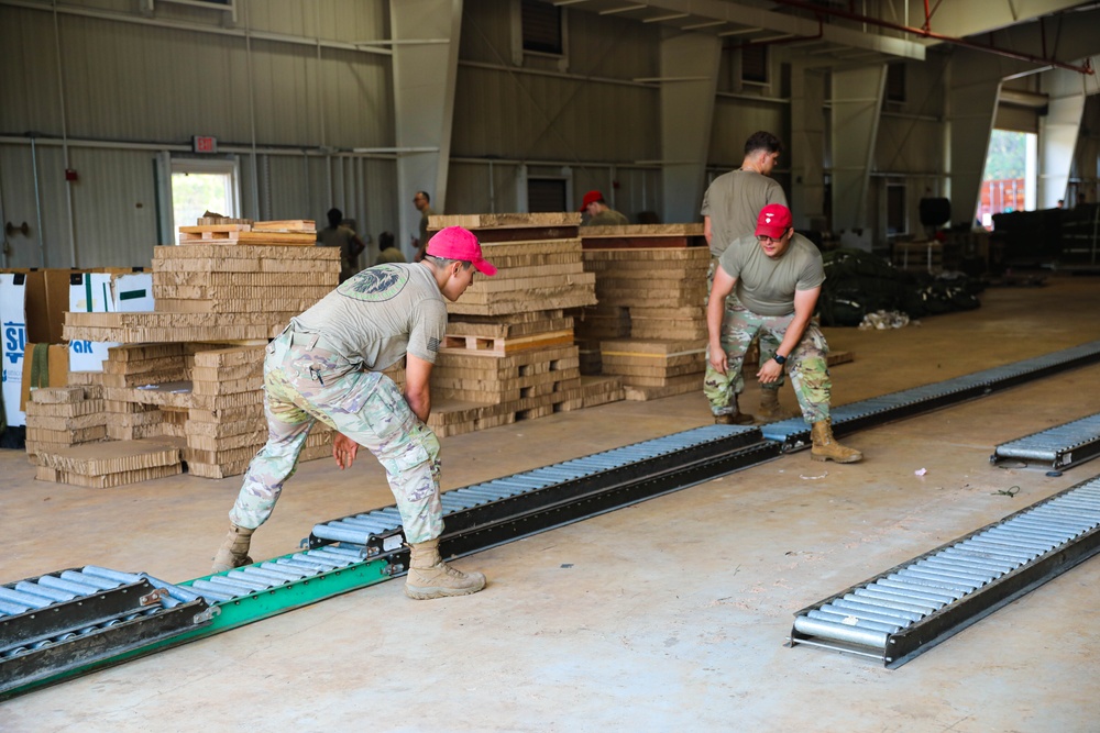 U.S. Army Parachute Riggers lift equipment