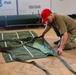 U.S. Army Parachute Rigger prepares to rig