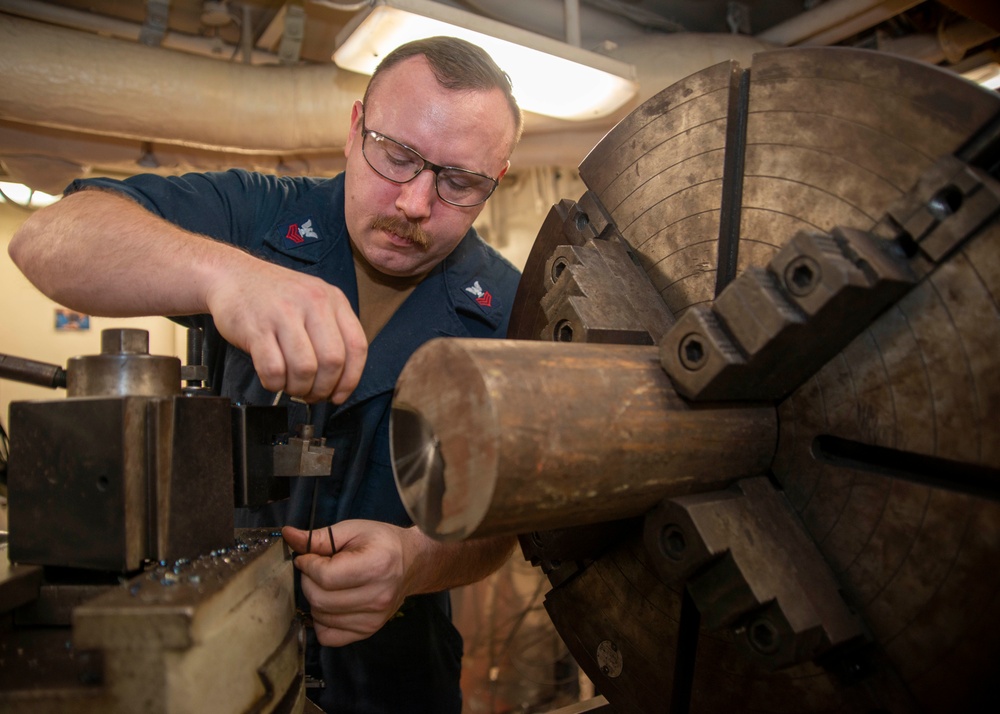 Sailor Prepares To Machine Metal Stock