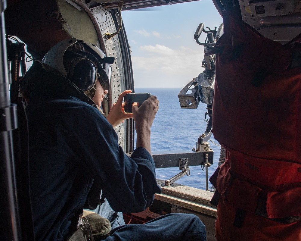 USS Ronald Reagan (CVN 76) Sailors reenlist during a flight in an MH-60S Sea Hawk, attached to Helicopter Sea Combat Squadron (HSC) 12