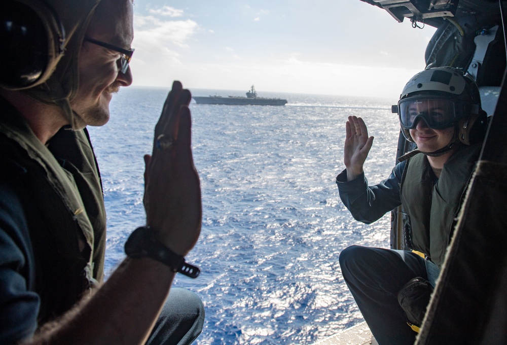 USS Ronald Reagan (CVN 76) Sailors reenlist during a flight in an MH-60S Sea Hawk, attached to Helicopter Sea Combat Squadron (HSC) 12