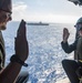 USS Ronald Reagan (CVN 76) Sailors reenlist during a flight in an MH-60S Sea Hawk, attached to Helicopter Sea Combat Squadron (HSC) 12