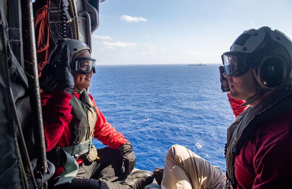USS Ronald Reagan (CVN 76) Sailors reenlist during a flight in an MH-60S Sea Hawk, attached to Helicopter Sea Combat Squadron (HSC) 12