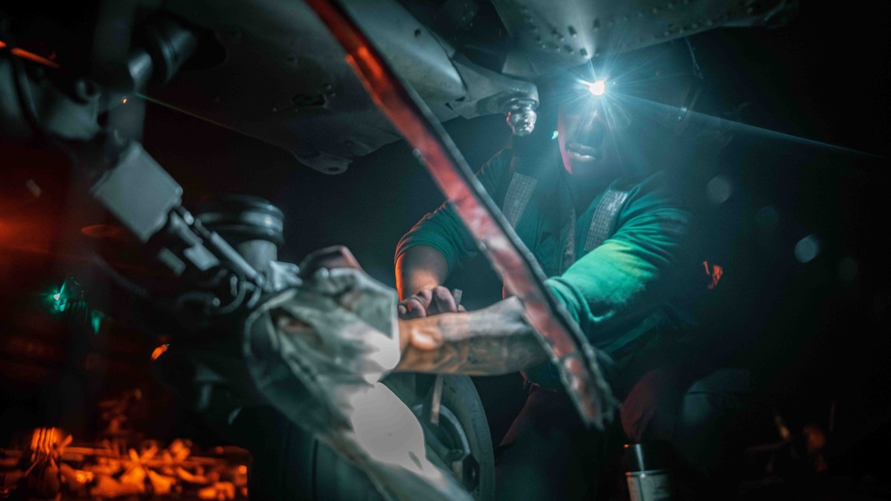 Sailor cleans MH-60S Sea Hawk aboard USS Carl Vinson