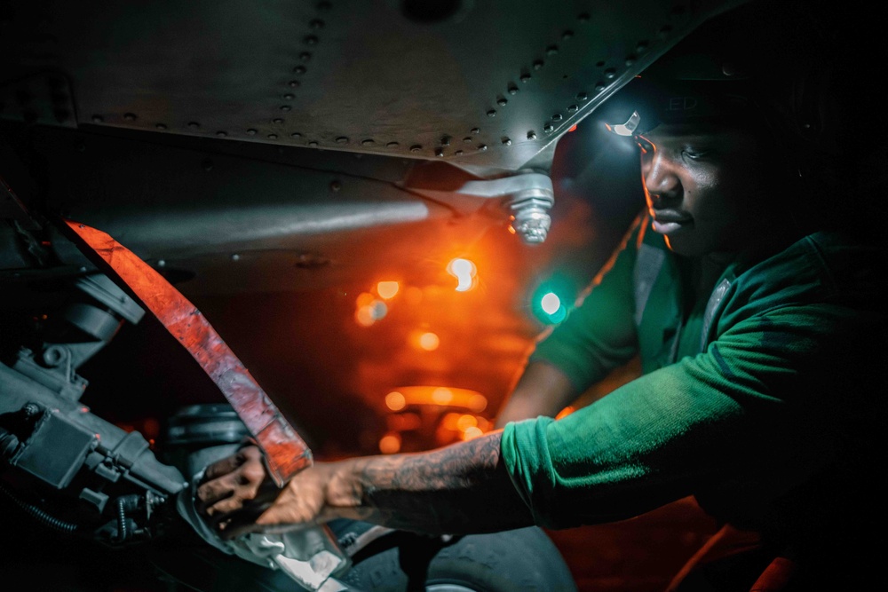 Sailor cleans MH-60S Sea Hawk aboard USS Carl Vinson