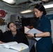 USS Ronald Reagan (CVN 76) Sailors review legal documents