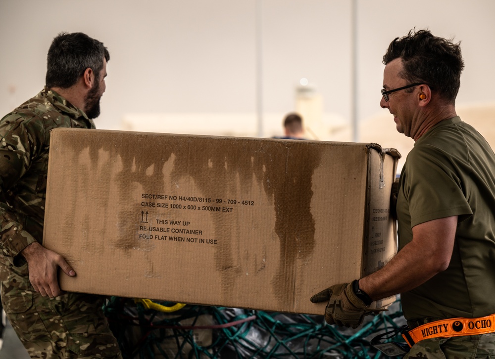 U.S. and Royal Air Forces integrate for cargo unloading, supporting Exercise Ferocious Falcon