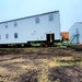 Contractors ‘drive’ World War II-era barracks buildings to new foundations at Fort McCoy